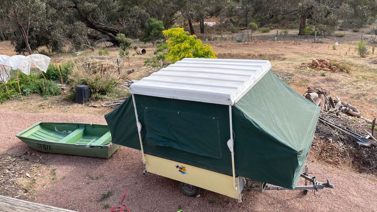 The Topagee camper opened up next to its companion boat.